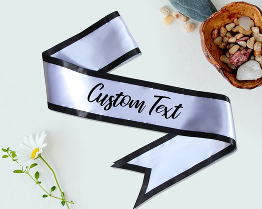 Elegant silver satin sash with black border and customizable text, perfect for formal events and special occasions.