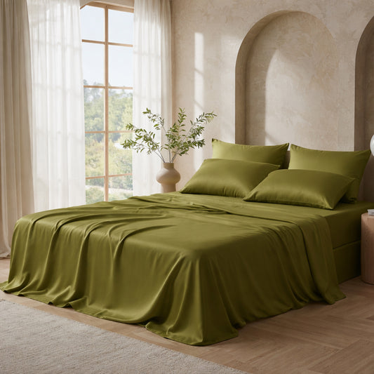 Mossy olive green satin bed sheets in a Mediterranean style bedroom with arched alcoves