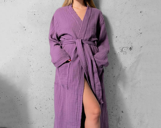 Woman wearing a plum purple muslin robe with a textured, breathable fabric, featuring a relaxed fit, waist tie, and deep pockets, perfect for stylish and comfortable loungewear.