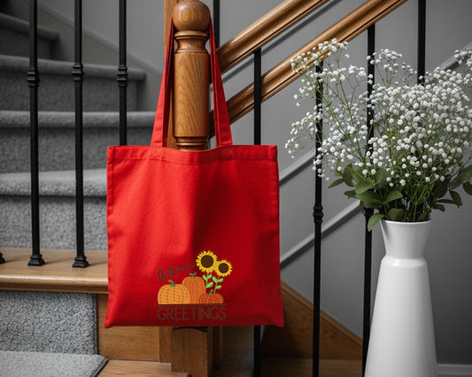 cotton tote bag with embroidered autumn pumpkins and sunflower design.
