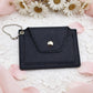 Black leather wallet with a gold button on a white lace background with flowers