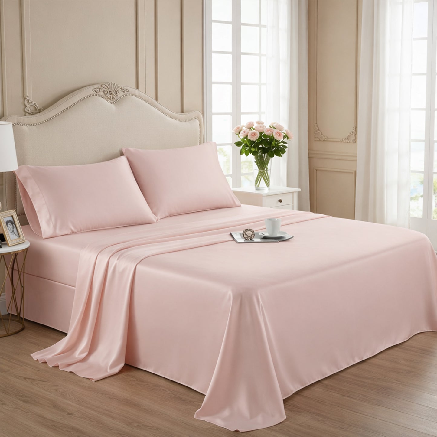 Elegant blush pink silk sheets on a classic tufted headboard bed with rose flower accents