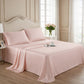 Elegant blush pink silk sheets on a classic tufted headboard bed with rose flower accents