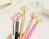 A collection of elegant diamond-topped pens in various colors, labeled "Bride" and "Bridesmaid," perfect for wedding gifts and favors.