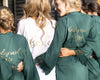 Bride in white robe with bridesmaids in green lace-trimmed robes made in USA 