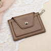 Brown leather cardholder with keychain on a lace background