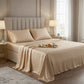 Premium champagne gold satin bedding set featuring a breakfast tray on a draped flat sheet