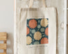 Beige tote bag with a chrysanthemum floral design and "November Flower" text.
