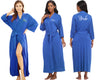Women wearing blue robes with personalized text on the front and back.