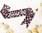 Black sash with pink and white hearts, featuring customizable text in elegant white script.