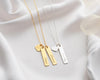  Gold and silver bar necklaces with personalized engravings and heart charms, beautifully displayed on soft white fabric.