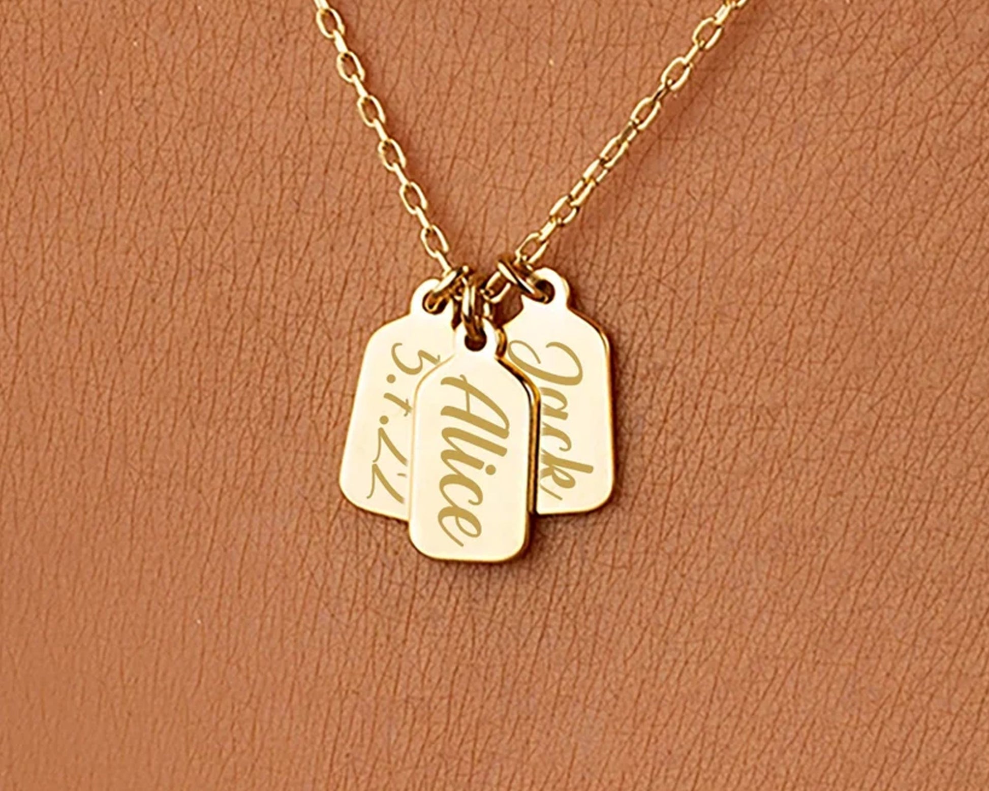 Gold necklace with personalized engraved name tags and a special date.