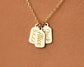Gold necklace with personalized engraved name tags and a special date.
