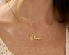 Gold nameplate necklace with Olivia in cursive on a delicate chain.