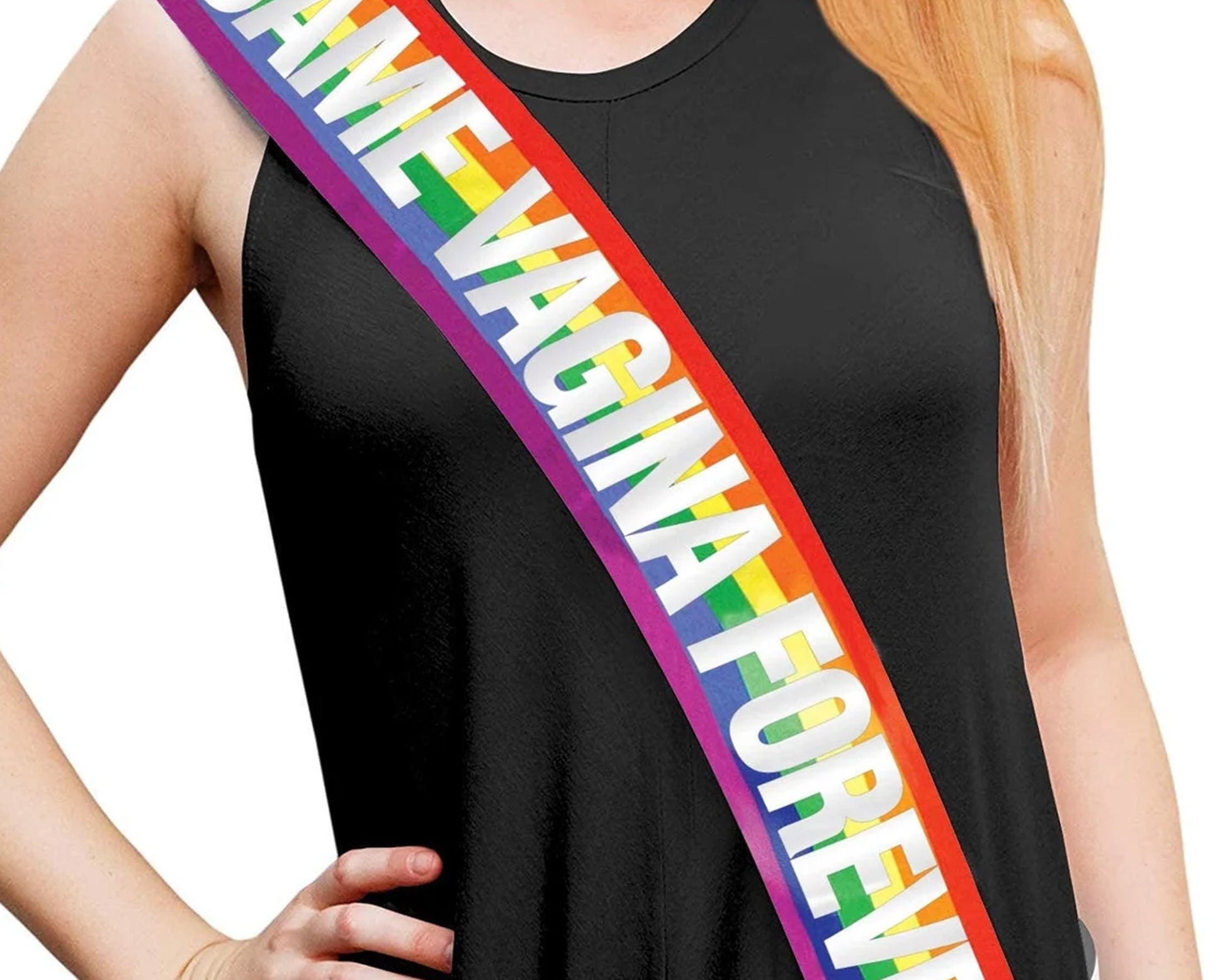  A person wearing an LGBT-colored sash with bold white text over a black sleeveless outfit.