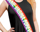 A person wearing an LGBT-colored sash with bold white text over a black sleeveless outfit.