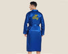 A male model wearing a royal blue satin robe with "King" and a gold crown embroidered on the back. The robe has a silky, luxurious texture and a matching belt, shown from a full back view.