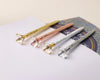 Luxurious diamond-topped pens in gold, rose gold, white, and silver, engraved with names for a stylish and personalized touch.