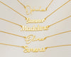 Gold name necklaces with cursive lettering on a white background.