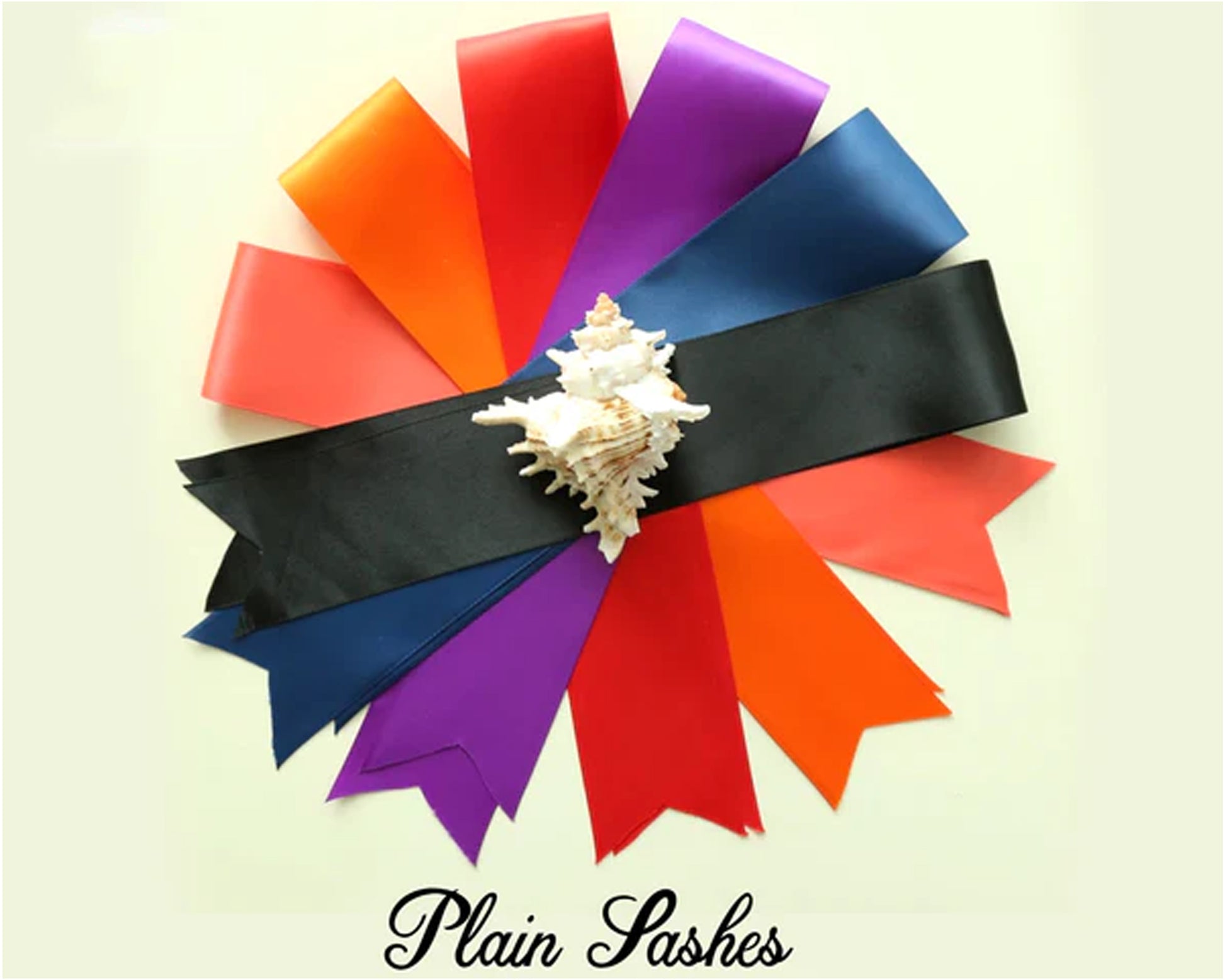 A collection of colorful plain sashes arranged in a fan shape with a seashell in the center.