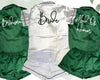 Satin pajama sets in emerald green and white, personalized with "Bride," "Bridesmaid," and "Maid of Honor" text.