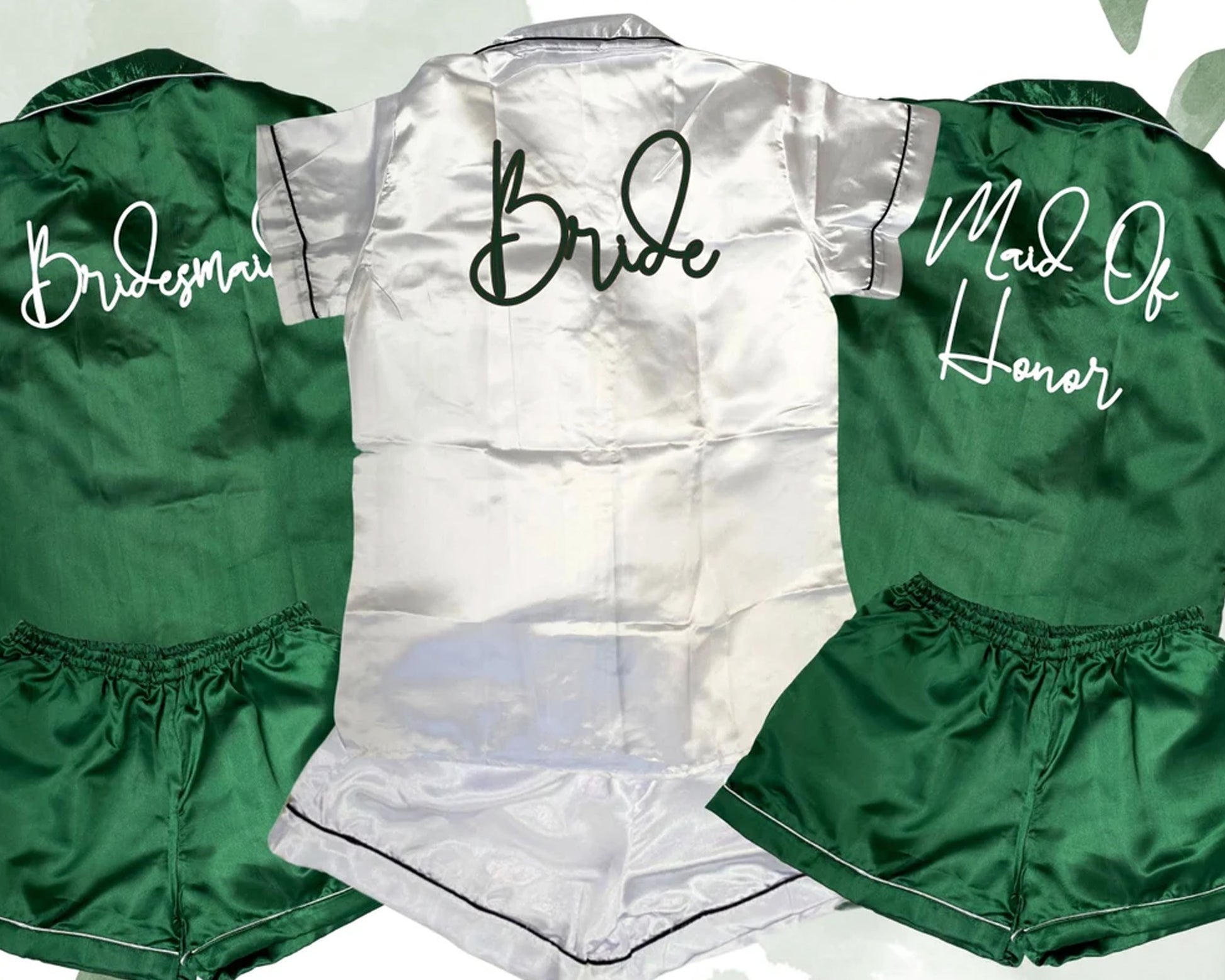 Satin pajama sets in emerald green and white, personalized with "Bride," "Bridesmaid," and "Maid of Honor" text.
