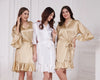 Elegant satin ruffle bridesmaid robes in champagne and white, perfect for wedding mornings and bridal parties.