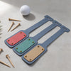 Three colorful BAG TAGS on a light surface with a golf ball and tees.
