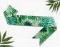 Elegant custom sash with a tropical leaves print, featuring personalized text for special occasions.