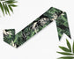 Satin sash with a vibrant tropical leaves print, perfect for themed events and celebrations.