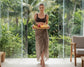 Woman holding a tray of fruits in a tropical setting