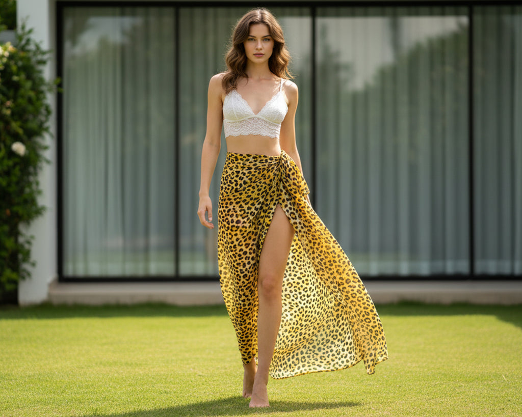 Woman wearing a cheetah print skirt and white top on a grassy area.