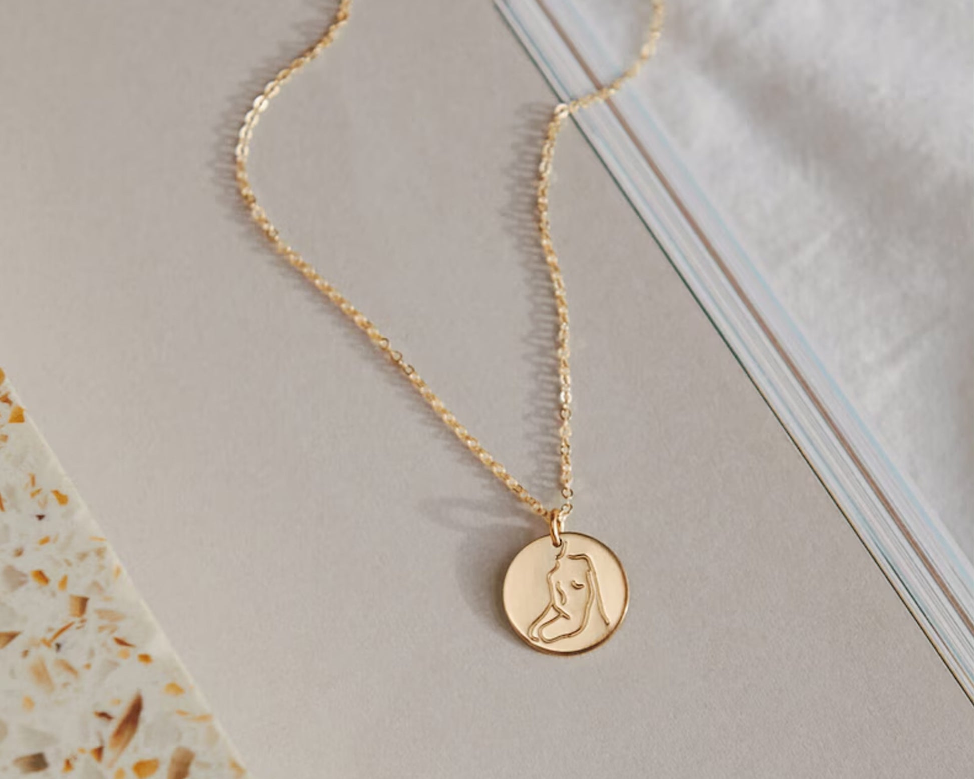 Elegant disc pendant with custom engraving for women.