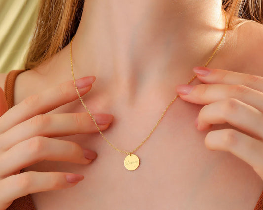 Elegant round necklace worn by a woman. 