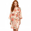 Woman wearing red rose floral satin robe with wrap tie front