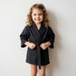 girl in a black waffle robe tied at the waist